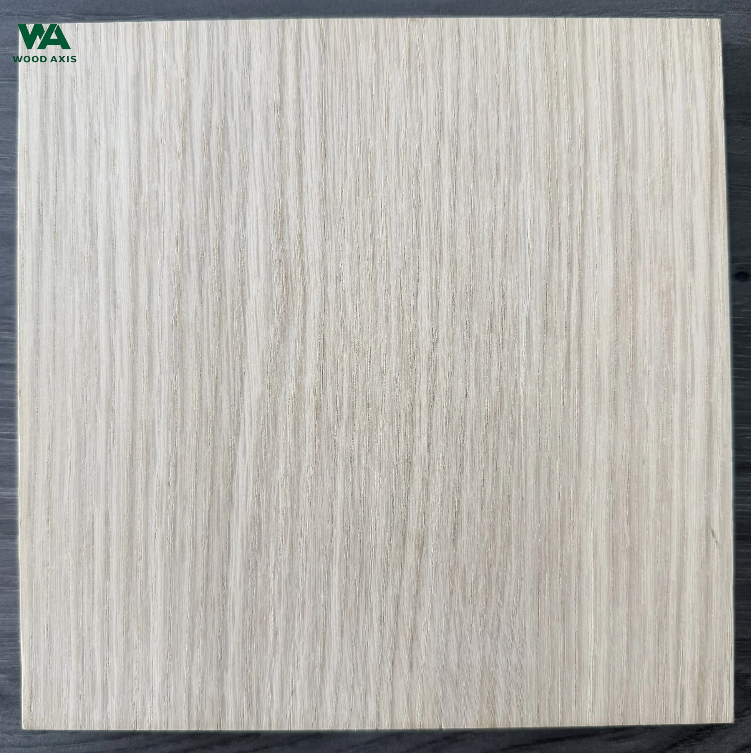 Close-up of natural white oak plywood grain, highlighting the light tan color and unique ray fleck pattern.