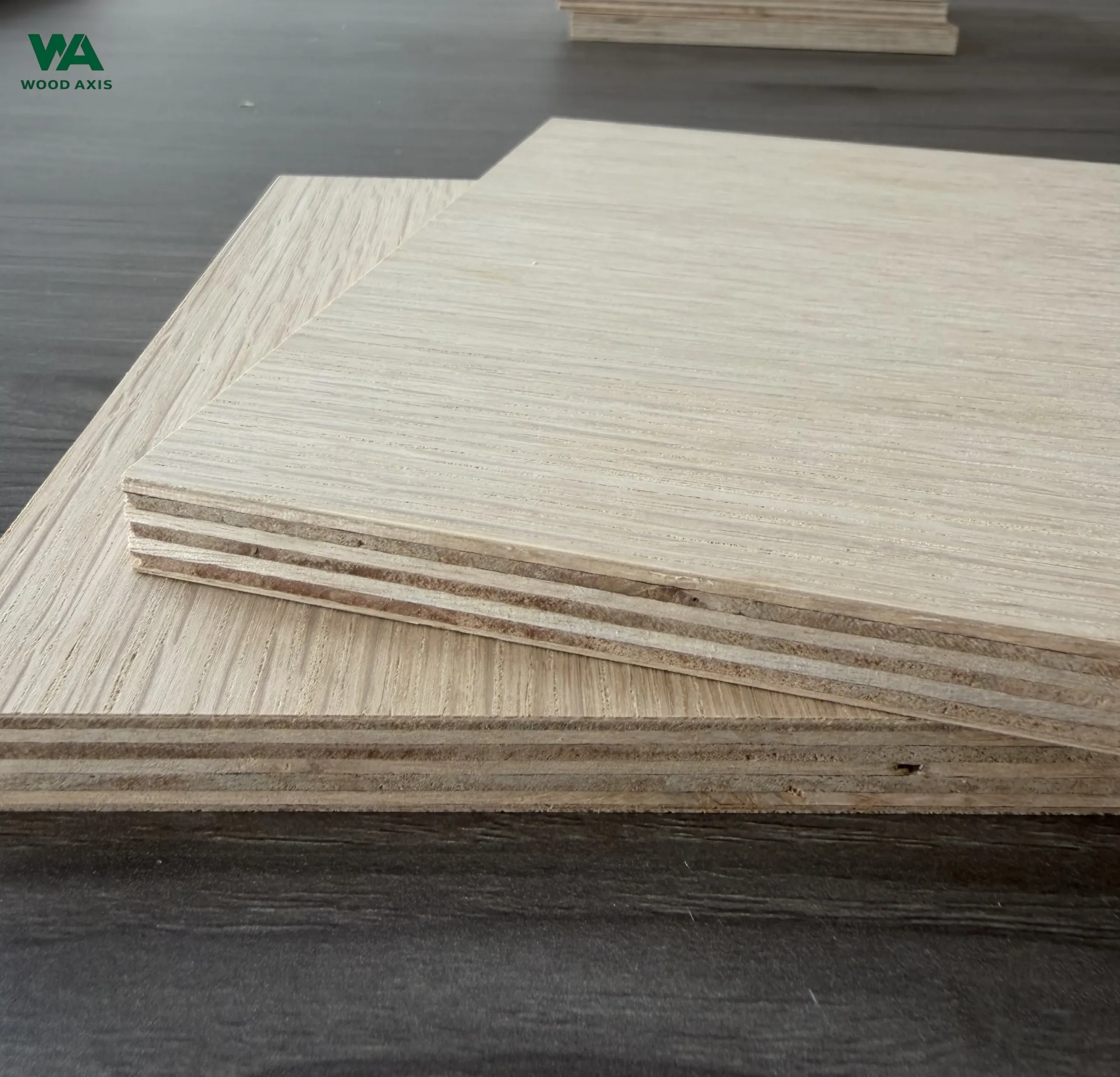 Macro view of a 3/4 inch white oak plywood cross-section, showing the detailed multi-layer veneer core structure with alternating void-free wood plies and tight glue lines.