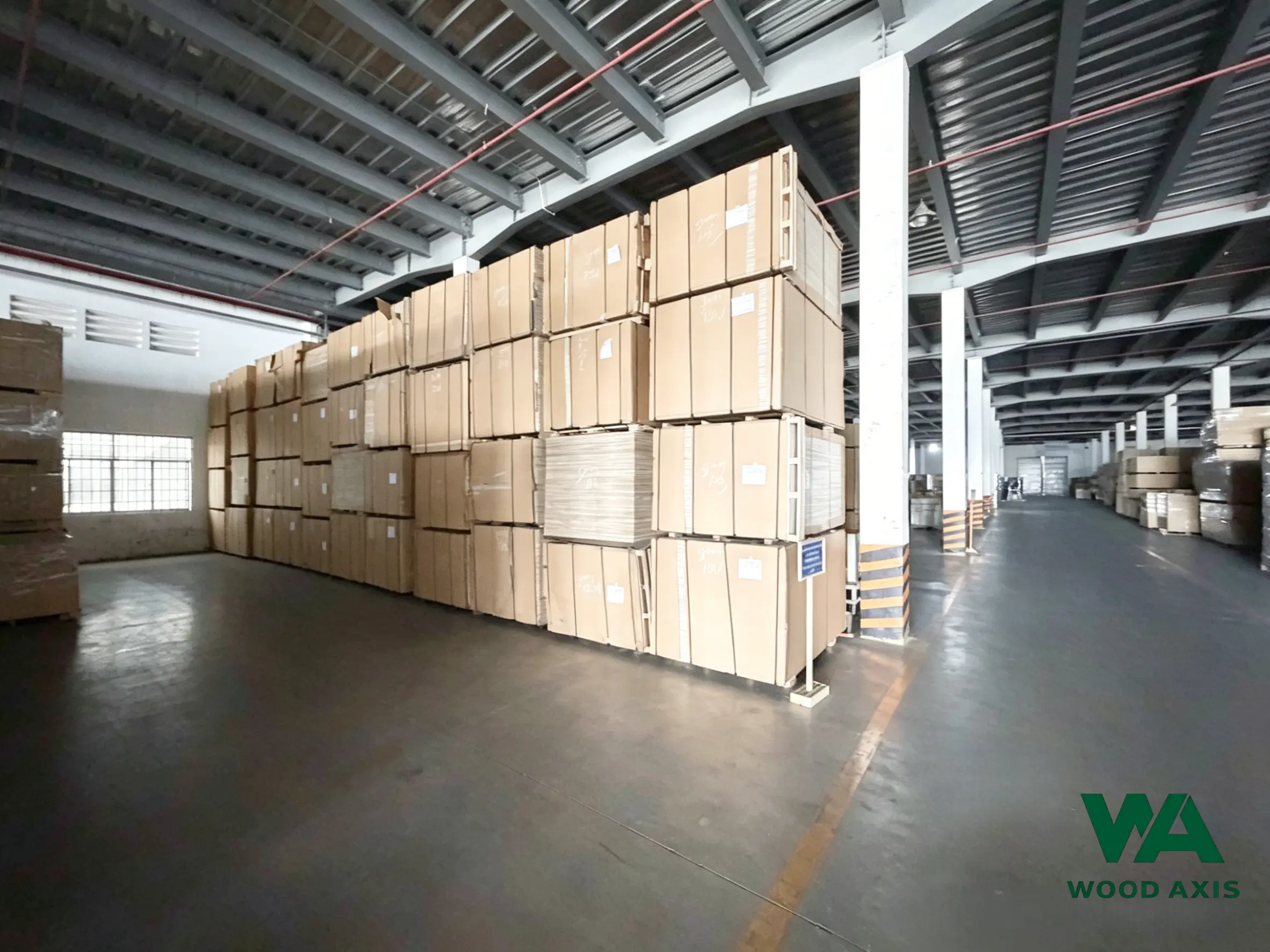 Large-scale finished goods warehouse with extensive inventory of plywood ready for export.