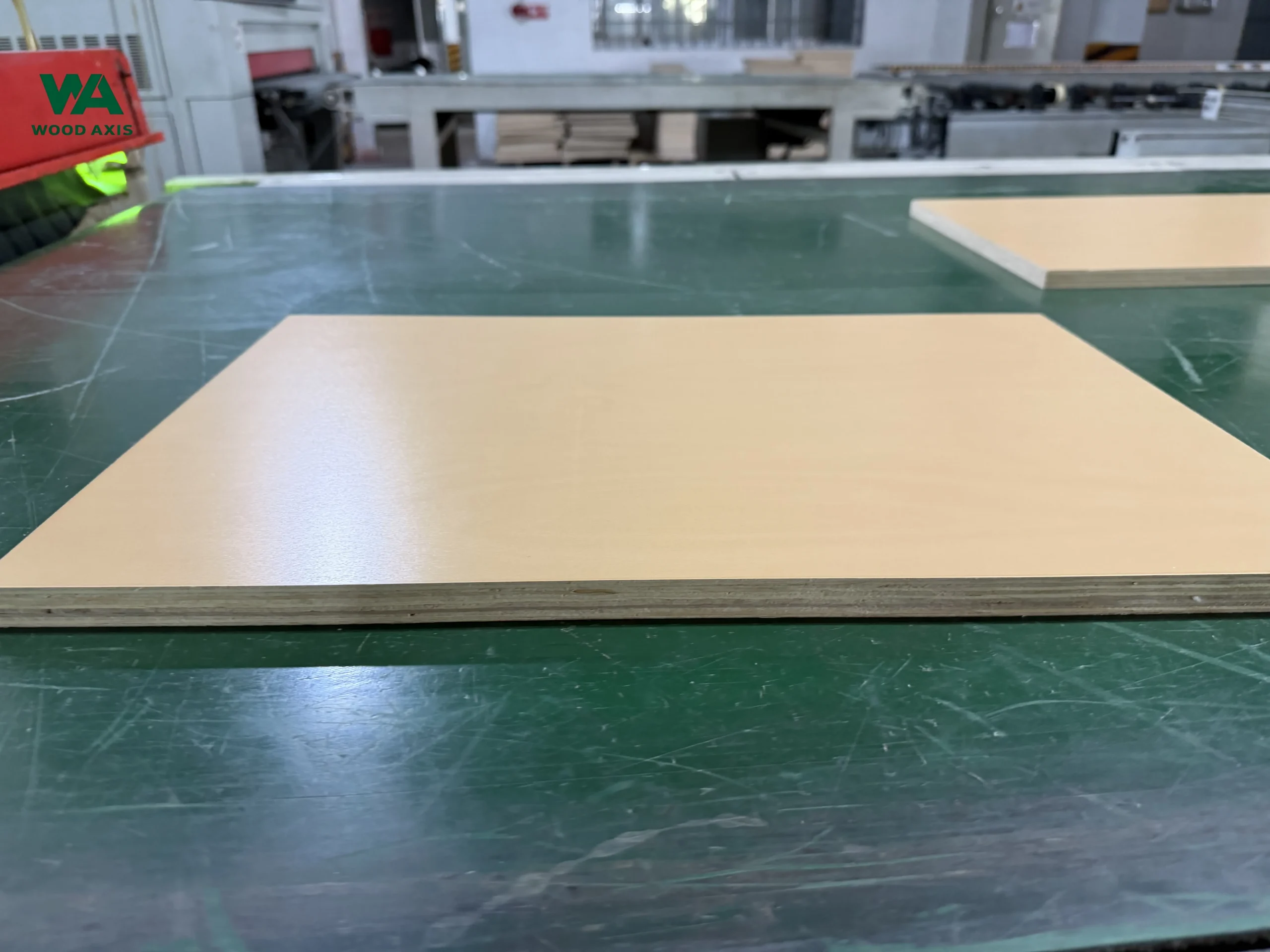 Blog 1 Industrial UV coating line applying high-gloss finish to laminated plywood panels, ensuring scratch resistance and durability.