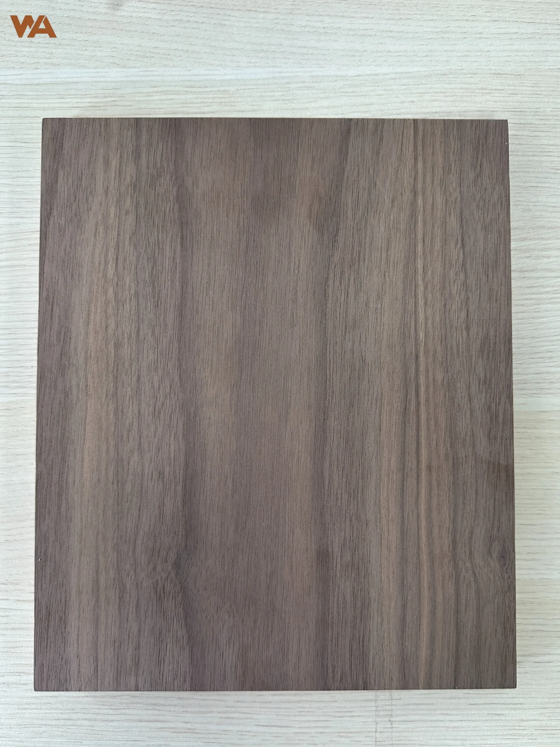 Close-up detail of black walnut plywood surface showing natural wood grain and veneer texture.