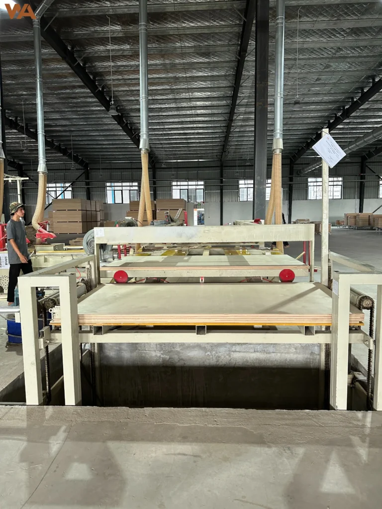 Total Cost of Ownership (TCO) in Plywood Sourcing: Beyond the FOB Unit Price 4 The automated lamination machine applying decorative veneer to plywood panels in a modern manufacturing facility.